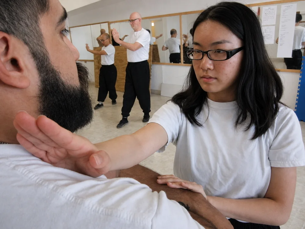 Two students at close range during Chi Sau sticky-hands practice