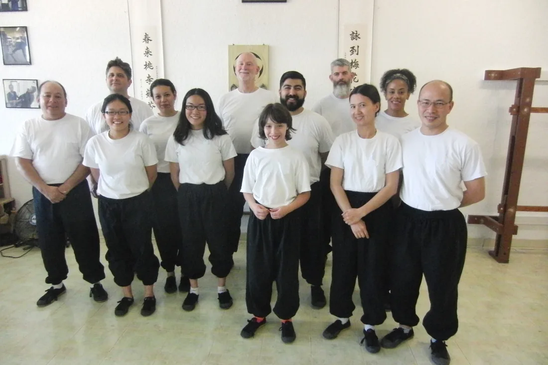 Students of all ages lined up together in the Dragon Martial Arts training hall