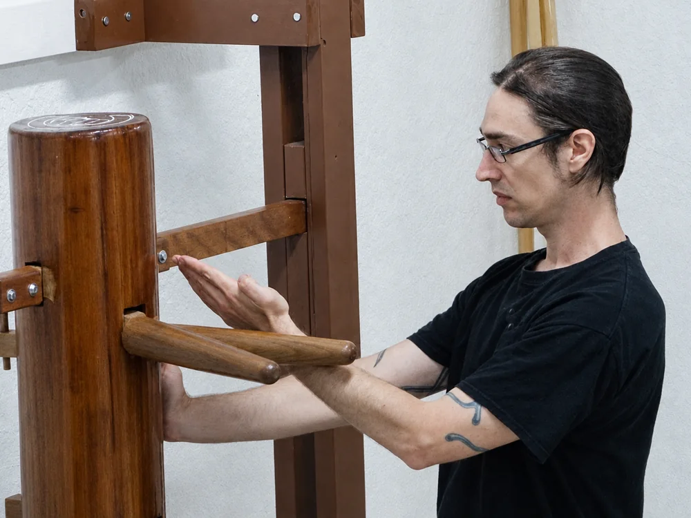A senior student training on the wooden dummy at Dragon Martial Arts