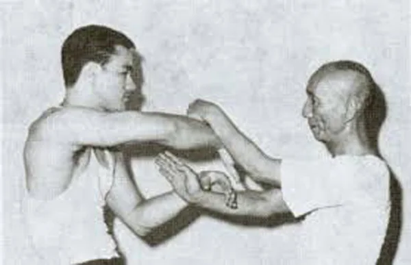 Bruce Lee and Grandmaster Ip Man practicing Wing Chun sticky hands