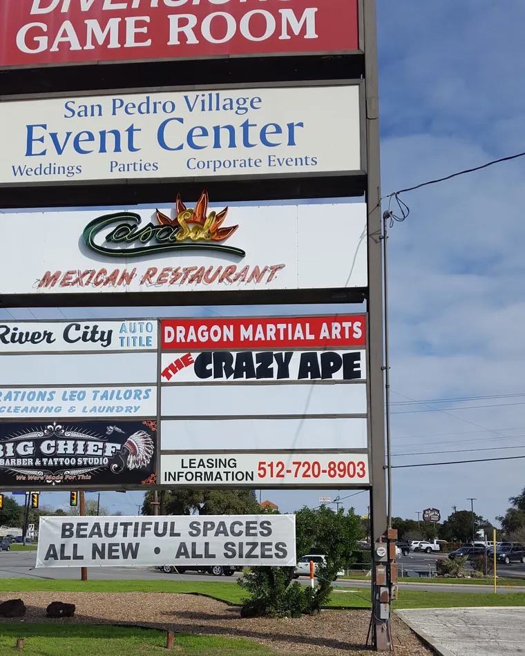The roadside pylon sign on San Pedro Avenue listing Dragon Martial Arts