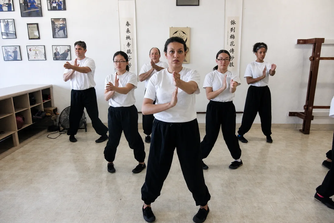 A line of students holding the Wing Chun stance during class